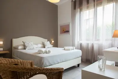 a bedroom with a bed with two towels on it at Mondello Martini in Mondello