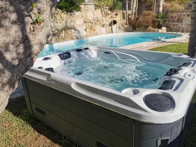 a large hot tub sitting next to a pool at Dependence Desiree in Alcamo