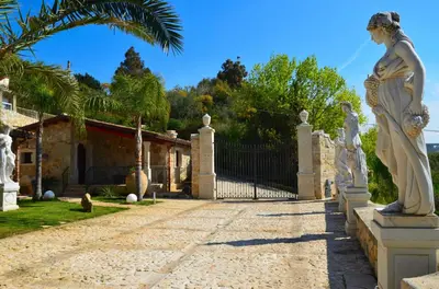 a statue of a woman on a fence in front of a house at Dependence Desiree in Alcamo