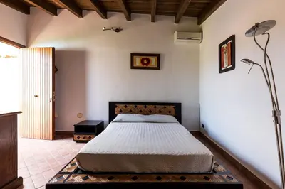 a bedroom with a bed in a room at Vero Sicily - Villa San Giorgio in Cinisi
