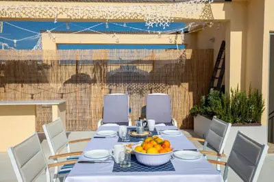 a table with a bowl of oranges on it at Maison Brigitte - Solemar Sicilia in Santa Flavia