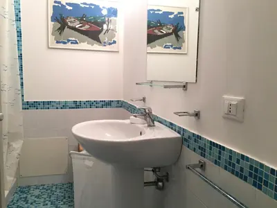 a bathroom with a sink and a toilet and a mirror at villa Anna Silvia Makari fiction rai 1 Casa Saverio La Manna in San Vito lo Capo