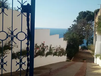 a gate with a view of the ocean from a house at villa Anna Silvia Makari fiction rai 1 Casa Saverio La Manna in San Vito lo Capo