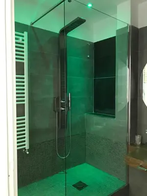 a shower with a glass door in a bathroom at Porta Maqueda in Palermo