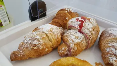 a tray of pastries and croissants on display at Porta Maqueda in Palermo