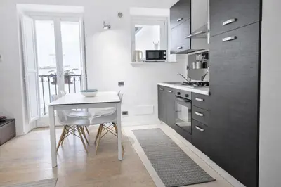 a kitchen with a table and a small table with a table at Palazzo Moncada Apartment in Palermo
