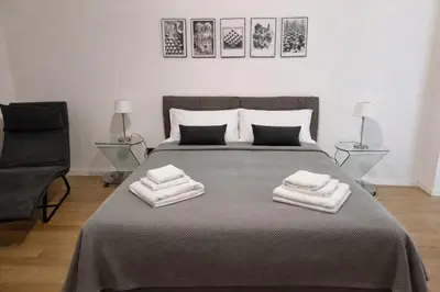 a bedroom with a bed with two towels on it at Palazzo Moncada Apartment in Palermo