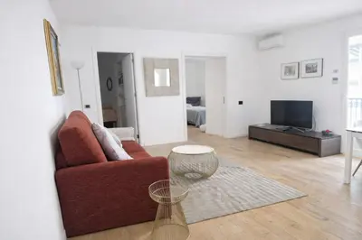 a living room with a red chair and a television at Palazzo Moncada Apartment in Palermo