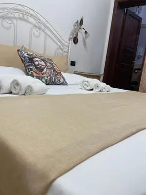 a bedroom with a bed with towels on it at Il Cortile in San Vito lo Capo