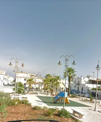 a park with a playground with a blue slide at Il Cortile in San Vito lo Capo