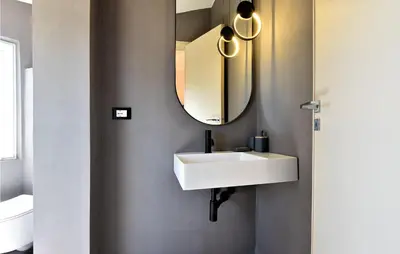 a bathroom with a white sink and a mirror at Villa Delle Sterlizie in Valguarnera