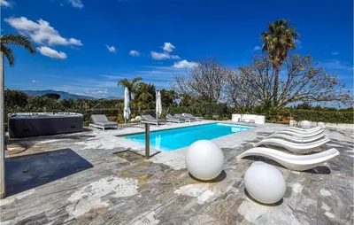 a swimming pool with lounge chairs next to a swimming pool at Villa Delle Sterlizie in Valguarnera