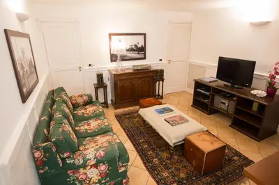 a living room with a couch and a tv at Dimora dei Leoni in Palermo