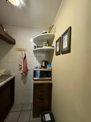 a small kitchen with a sink and a microwave at Voile Rouge in Palermo