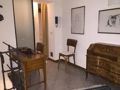 a room with a table and a chair and a desk at Voile Rouge in Palermo