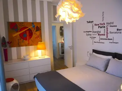 a bedroom with a bed and a painting on the wall at Gebel Grin in Palermo