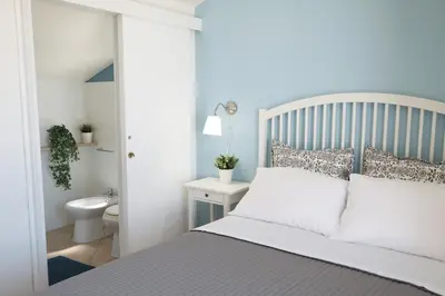 a bedroom with a bed and a bathroom with a toilet at Blu Marea in Macari