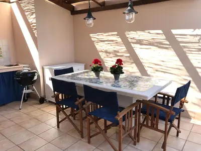 a kitchen with a table and chairs with flowers on it at Blu Marea in Macari