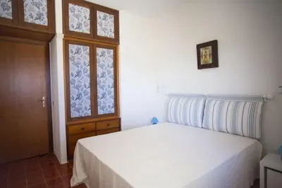 a bedroom with a white bed and a window at Villa sul mare in Palermo
