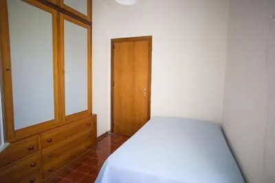 a bedroom with a bed and a wooden cabinet at Villa sul mare in Palermo