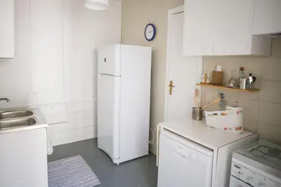 a white kitchen with a refrigerator and a sink at Villa sul mare in Palermo