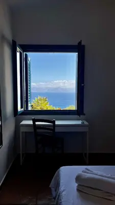 a bedroom with a window with a desk and a chair at Casa di Cri in San Vito lo Capo