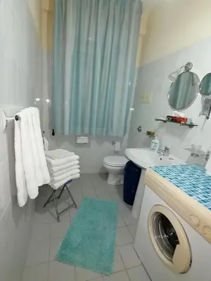 a bathroom with a sink and a washing machine at casa Barone in Balestrate