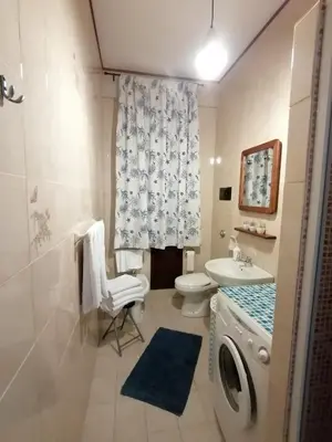a bathroom with a washing machine and a sink at casa Barone in Balestrate