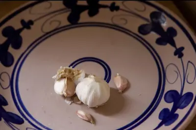 two cloves of garlic sitting on a plate at Casa del Contrabbasso in Palermo