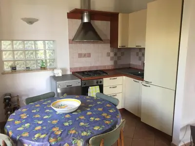 a bedroom with a bed and two lamps and a window at Villa Nadia con splendida vista mare in Castellammare del Golfo