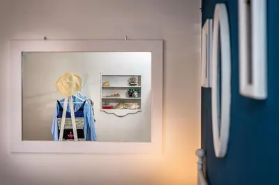 a mirror in a room with a hat on a shelf at Le Maioliche in Castellammare del Golfo