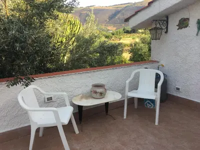 a bathroom with a sink and a toilet and a window at Villino Fraginesi in Castellammare del Golfo
