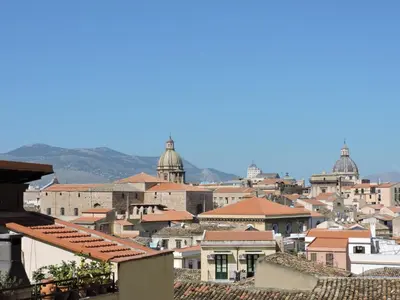 a view of a city from the roofs of buildings at Hotel Concordia in Palermo