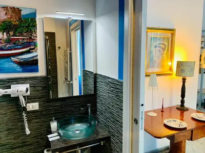 a bathroom with a sink and a mirror at La Maison del Sole in Palermo