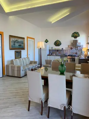 a living room with a table and chairs at La Maison del Sole in Palermo