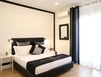 a bedroom with a large bed with a black headboard at La Terrazza Palace B&B in Palermo