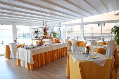 a dining room with tables and chairs in a building at La Terrazza Palace B&B in Palermo