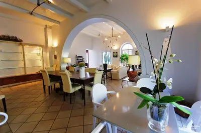 a dining room and living room with a table and chairs at B&B Casa Ruffino in Balestrate