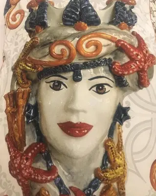a painting of a woman with pretzels on her head at House Il Conte in Palermo