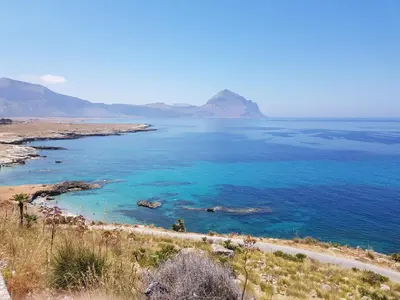 a view of the ocean with mountains in the background at Bilocale Mini Very in San Vito lo Capo