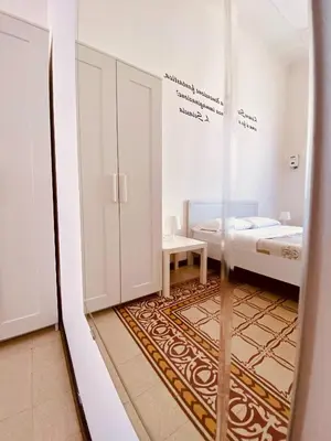 a small room with a bed and a glass door at Liolà Home #Teatro Massimo in Palermo