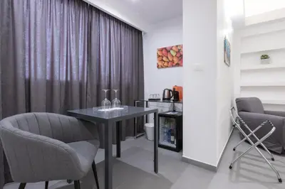 a dining room with a table and two chairs at Suite Palermo Apartment in Palermo