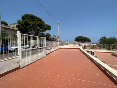 a walkway with a white fence on a bridge at Villino Addaura in Lido di Mondello
