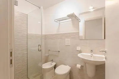 a bathroom with a sink and a toilet and a mirror at Case Vacanza appartamenti Trinacria in San Vito lo Capo