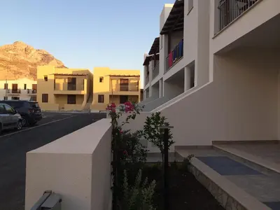 a building with flowers on the side of a street at Case Vacanza appartamenti Trinacria in San Vito lo Capo