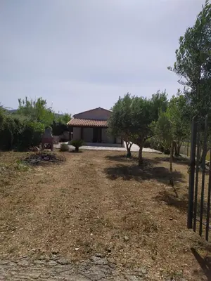 a yard with a house in the background at Antico Rustico in Scopello