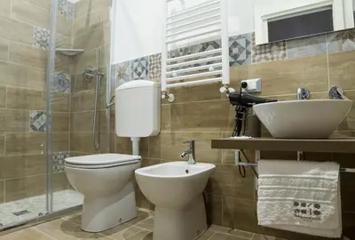 a bathroom with a toilet and a sink at Bagnasco 18 suite&terrace in Palermo