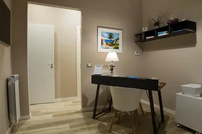 a room with a desk with a chair and a door at Bagnasco 18 suite&terrace in Palermo