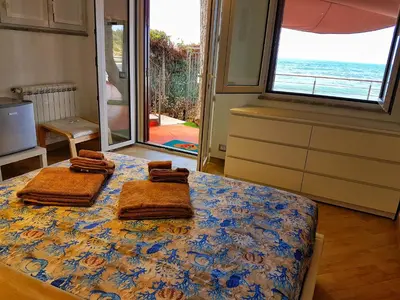 a bedroom with a bed with towels on it at Brezza Marina Guesthouse in Cefalù