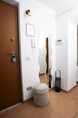 a room with a door and a stool in a room at Montesanto 13 in Palermo